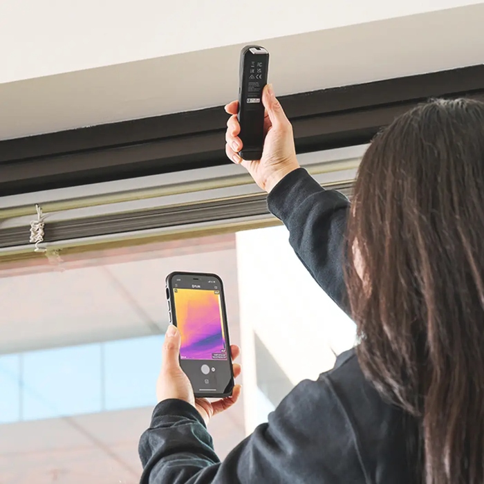 Teledyne Flir One Edge Compact Thermal Camera woman holding device and phone showing thermal image.